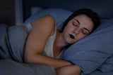 Person sleeping peacefully wearing AirCool Quiet Night mouth tape